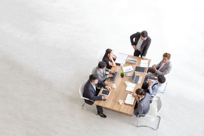 High angle view of people sitting on wall