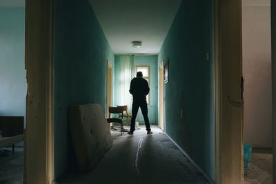 Man standing in corridor