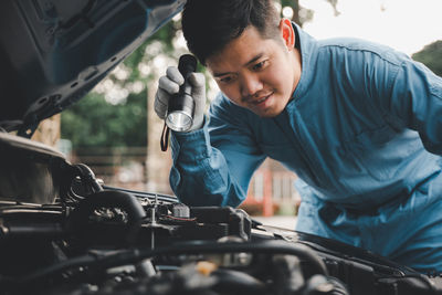 Man repairing car