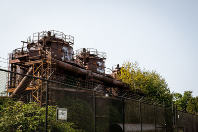 Low angle view of factory against clear sky