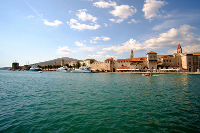 Sea with buildings in background