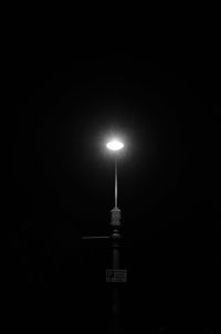 Low angle view of illuminated street light at night