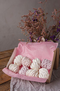 High angle view of pink flower on table against wall