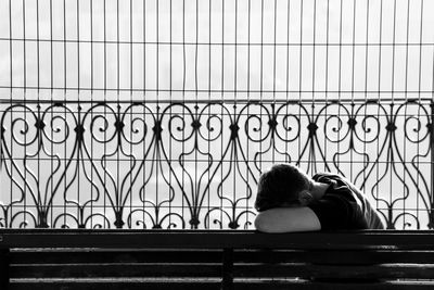 Rear view of couple kissing against window
