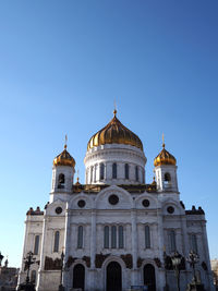 High section of built structure against clear blue sky