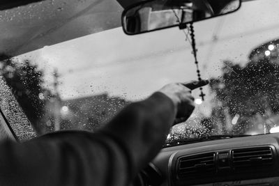 Midsection of man driving car