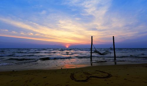 Scenic view of beach against sky during sunset