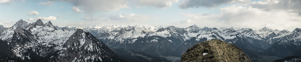 Scenic view of mountains against cloudy sky