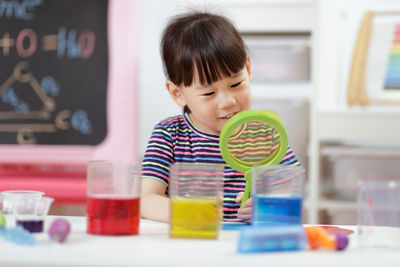 Young girl play science experiments for homeschooling