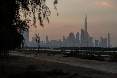 View of buildings in city during sunset