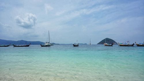 Sailboats in sea against sky
