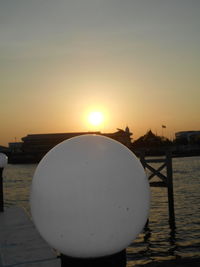 Close-up of sea against clear sky during sunset