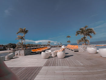 View of swimming pool by sea against sky