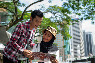 Young man smiling woman in city