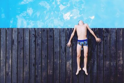 Woman relaxing on wooden wall