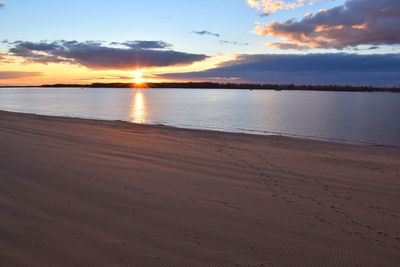 View of calm beach at sunset
