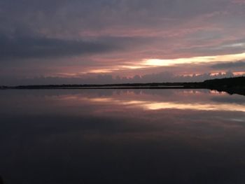 Scenic view of calm lake at sunset