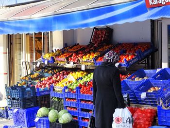 Midsection of man for sale at market stall