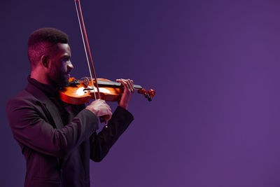 Low angle view of violin against sky