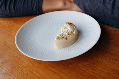 High angle view of hand in plate on table
