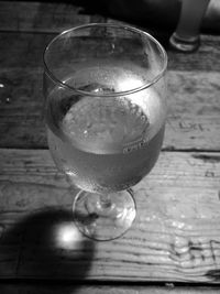 Close-up of wine glass on wooden table