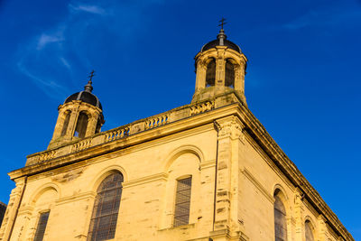 Low angle view of historic building against blue sky