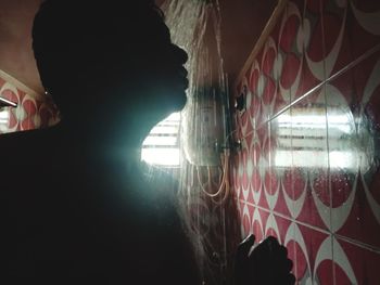 Close-up of woman standing by window