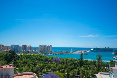 View of city by sea against sky