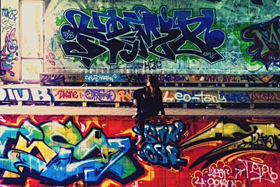 Low section of man painting on wall