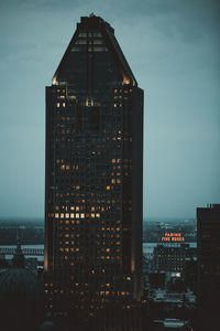 Illuminated buildings in city at dusk