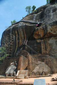 Low angle view of rock formation against sky