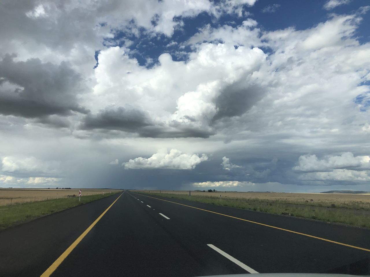 EMPTY ROAD AGAINST CLOUDY SKY