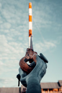 Close-up of coin-operated binoculars on metal against sky