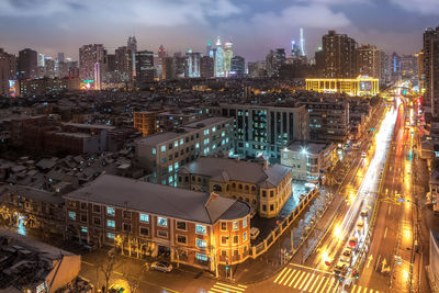 High angle view of illuminated buildings in city at night