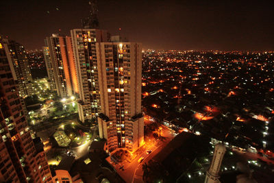 High angle view of illuminated buildings in city at night