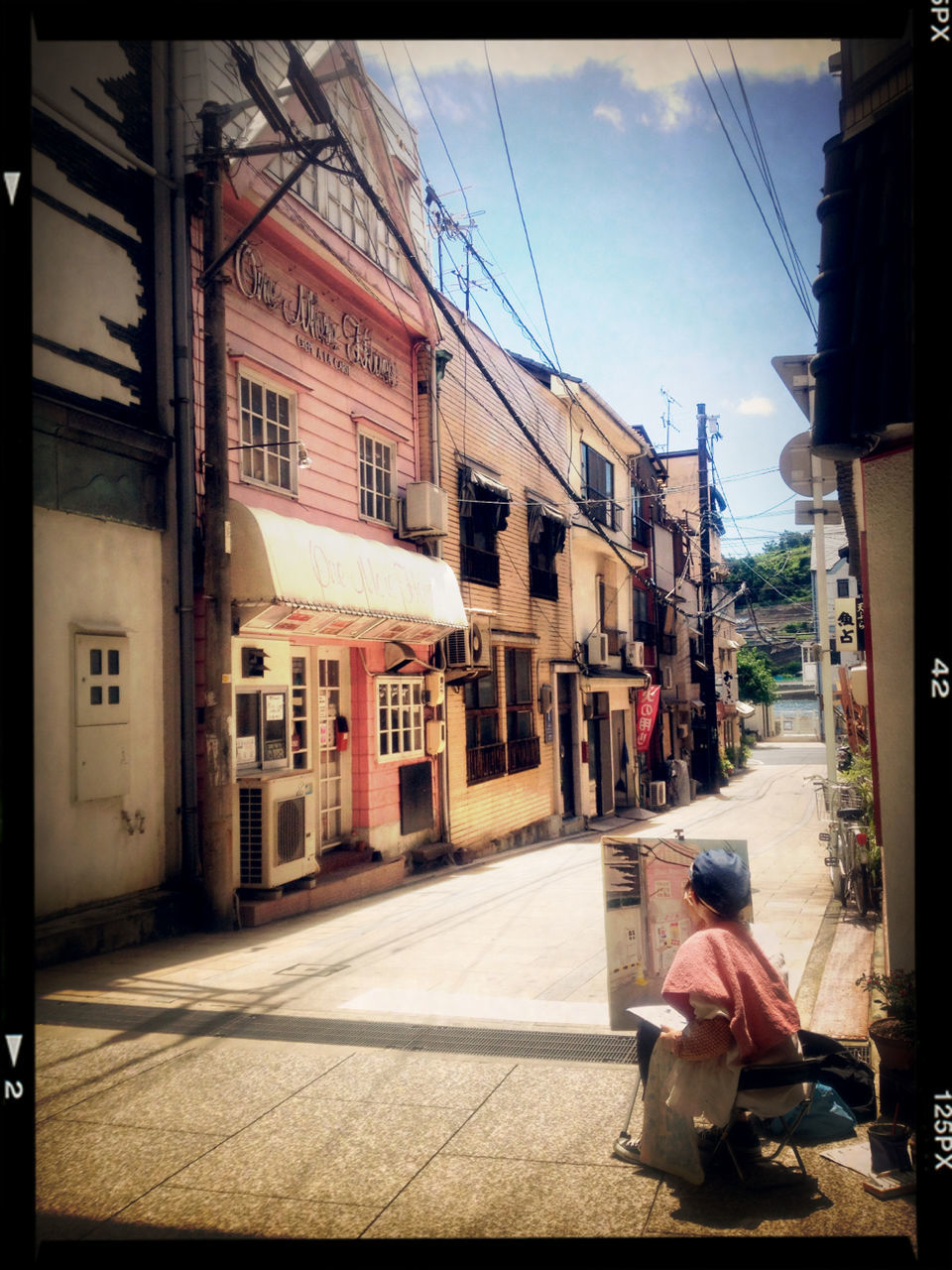 building exterior, architecture, transfer print, built structure, street, transportation, city, auto post production filter, sky, car, men, mode of transport, land vehicle, city life, road, sunlight, sidewalk, day