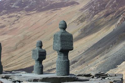 Cross on mountain against sky