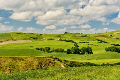 Scenic view of golf course against sky