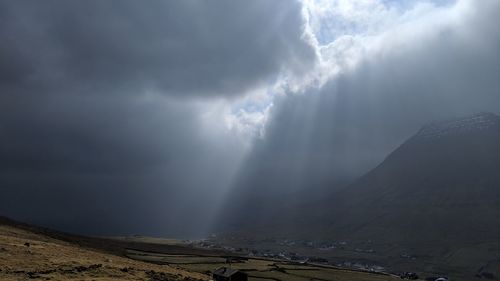 Scenic view of mountain against cloudy sky