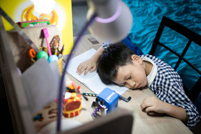 High angle view of boy on table
