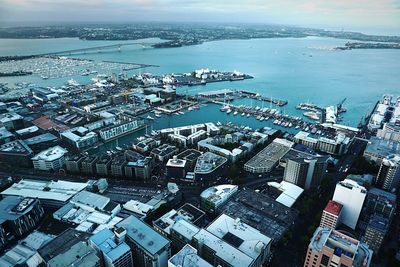 High angle view of buildings by sea against sky