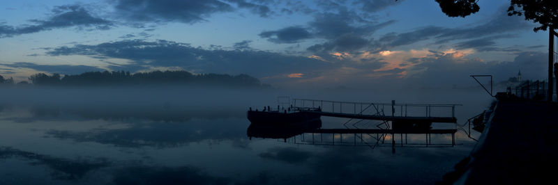 Boats in lake at sunset