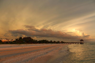 Scenic view of beach against sky during sunset