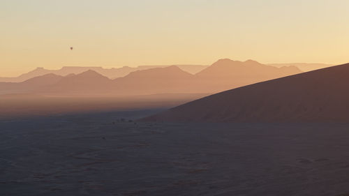 Scenic view of mountains against sky during sunset