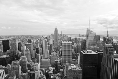 Empire state building with cityscape against sky