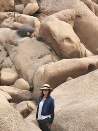 Portrait of young man standing on rock