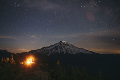 Scenic view of mountain against star field at night