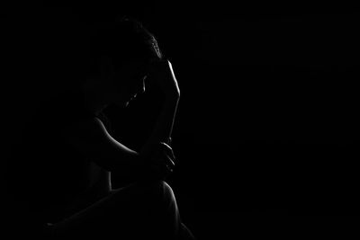 Woman against black background