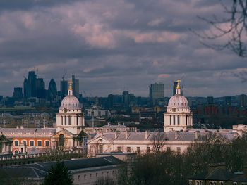 View of cityscape against cloudy sky