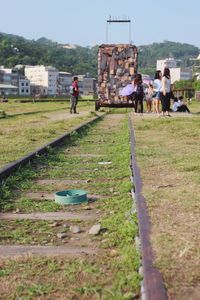 People in park by city against sky